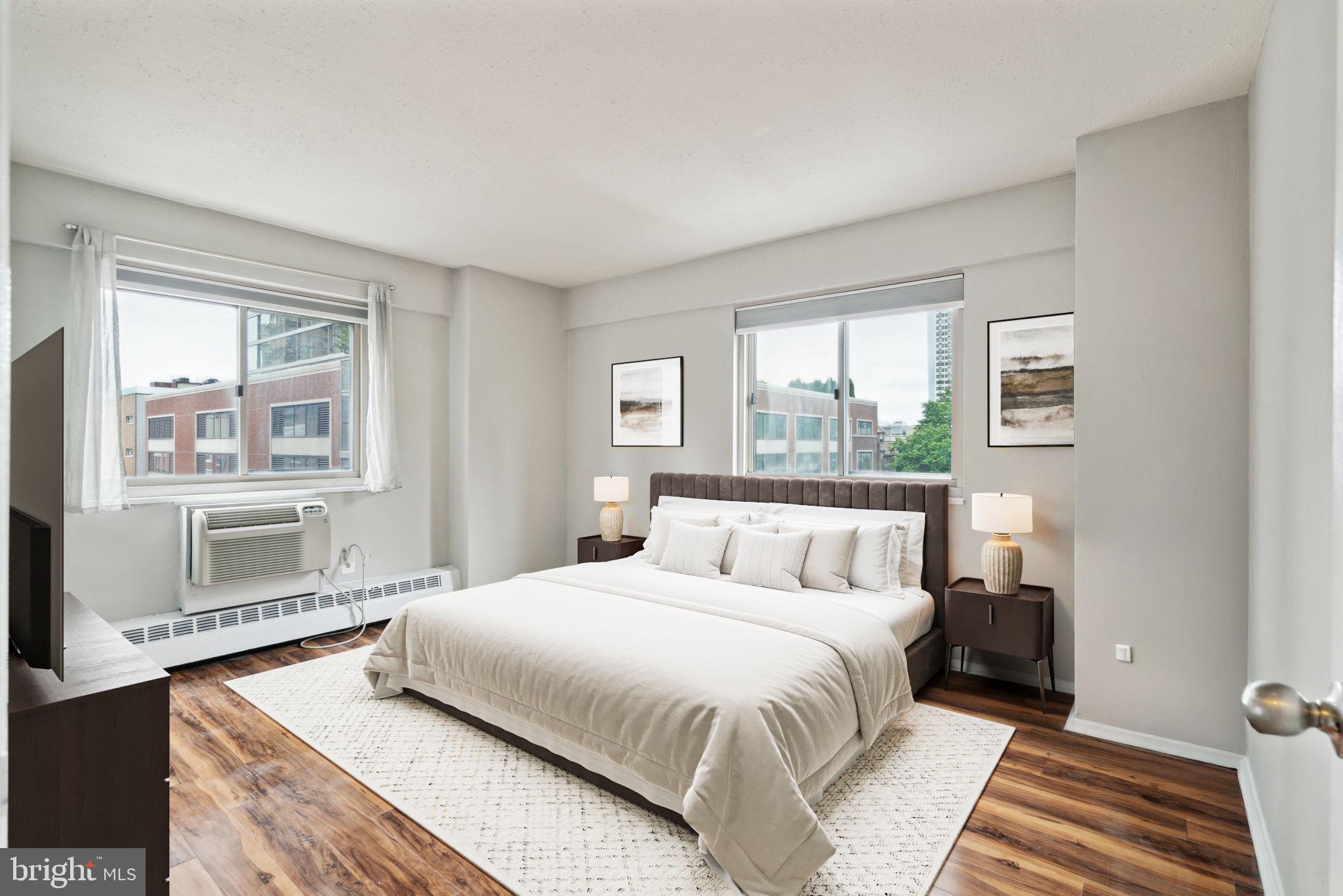 2101 Chestnut Street, Unit 415A Philadelphia, PA 19103 - Photo 2 of 20 a bedroom with a bed and wooden floor