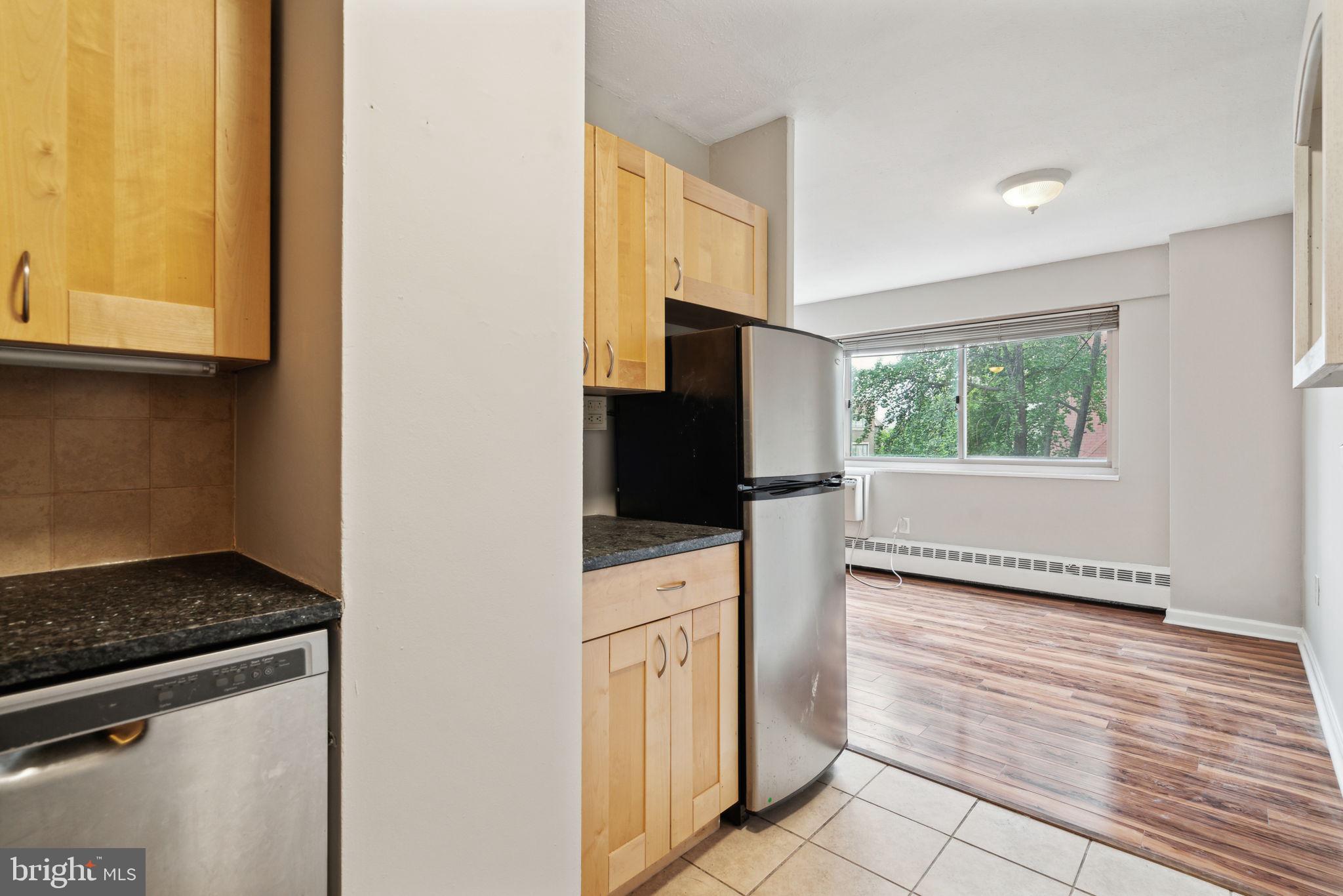 2101 Chestnut Street, Unit 415A Philadelphia, PA 19103 - Photo 6 of 20 a kitchen with a stove a sink and a refrigerator