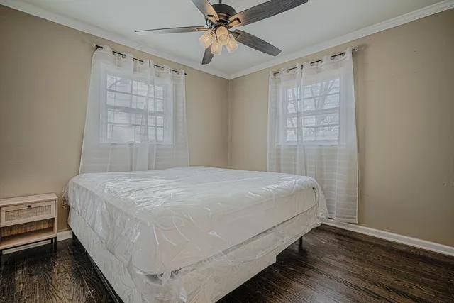 a bedroom with a bed and a window