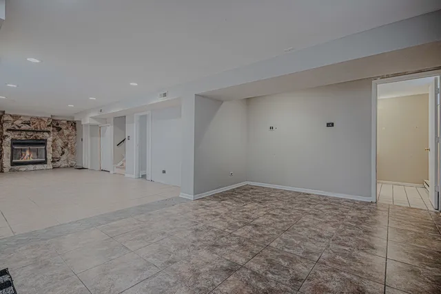 a view of a room that has a bed and a table in it