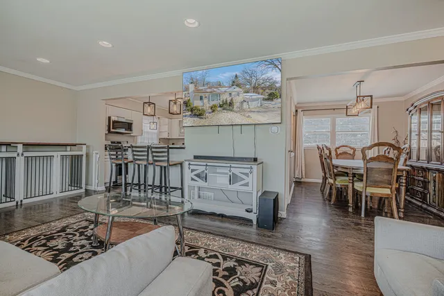 a living room with furniture a dining table and kitchen view