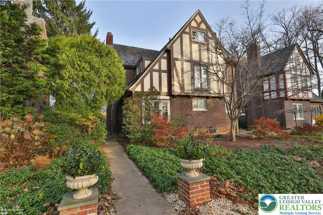 a view of a house with brick walls