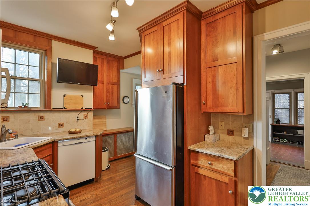 1808 Sycamore Street Bethlehem, PA 18017 - Photo 19 of 55 a kitchen with stainless steel appliances granite countertop a refrigerator a stove and a sink with wooden floor