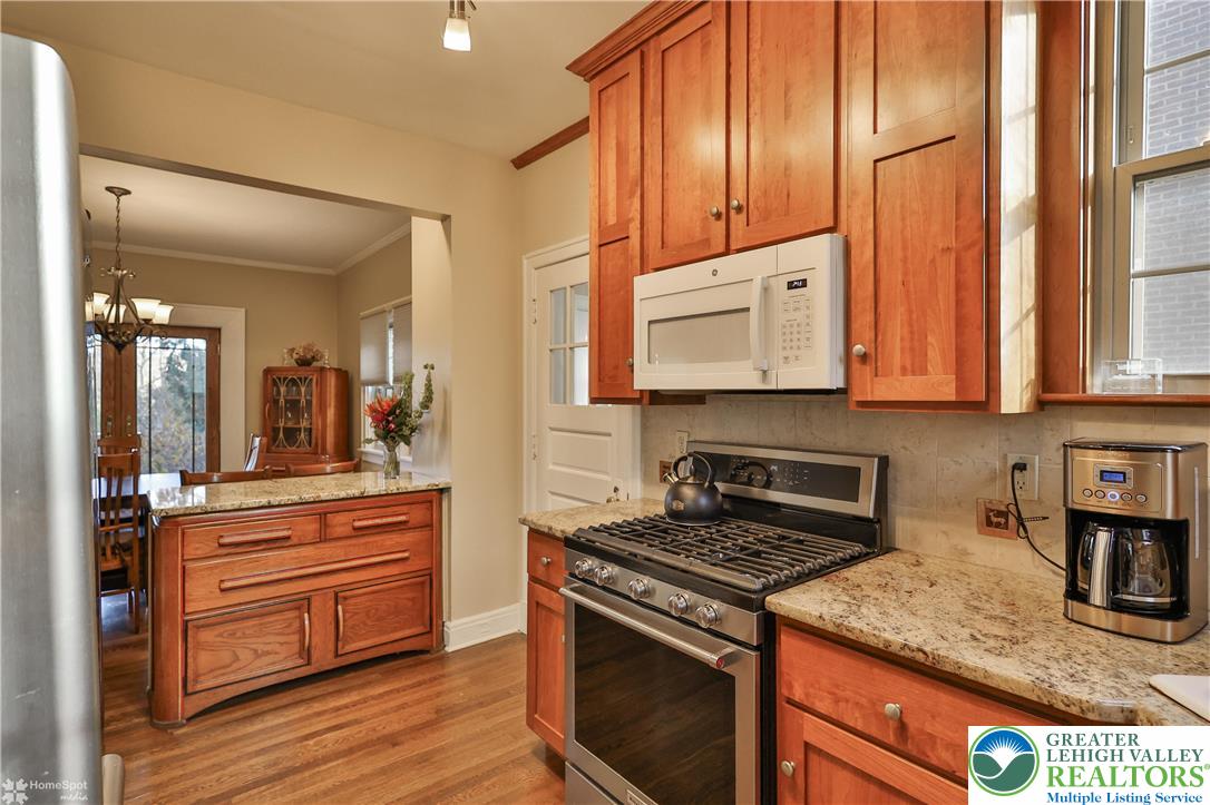 1808 Sycamore Street Bethlehem, PA 18017 - Photo 20 of 55 a kitchen with stainless steel appliances granite countertop a stove and a wooden cabinets