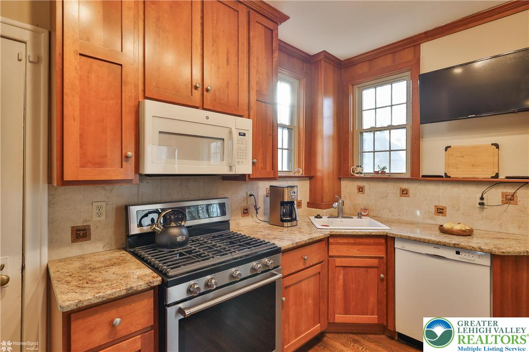 1808 Sycamore Street Bethlehem, PA 18017 - Photo 21 of 55 a kitchen with stainless steel appliances granite countertop a sink stove and cabinets