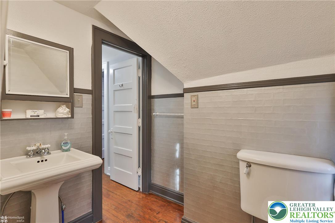 1808 Sycamore Street Bethlehem, PA 18017 - Photo 40 of 55 a bathroom with a sink a toilet and a mirror