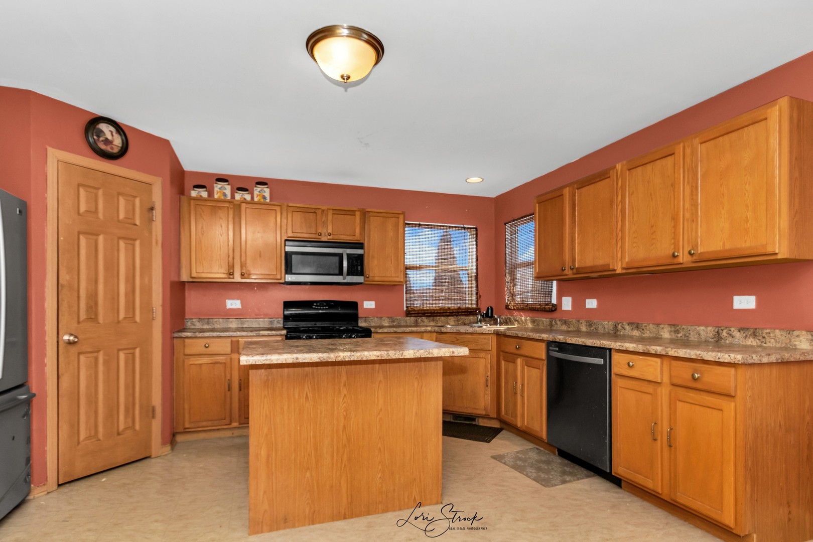 6419 Roth Drive Joliet, IL 60431 - Photo 9 of 13 a kitchen with stainless steel appliances granite countertop a stove top oven a sink dishwasher a dining table and chairs with wooden floor