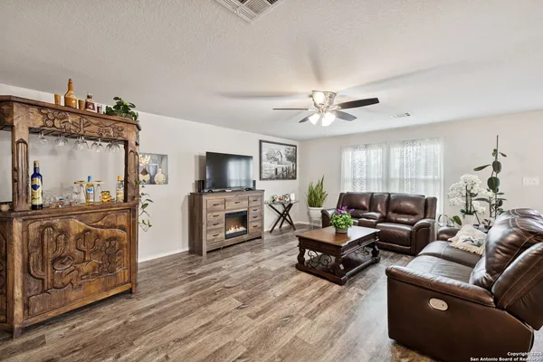 a living room with furniture and wooden floor