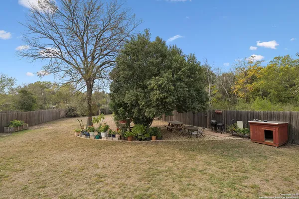 a backyard of a house with table and chairs