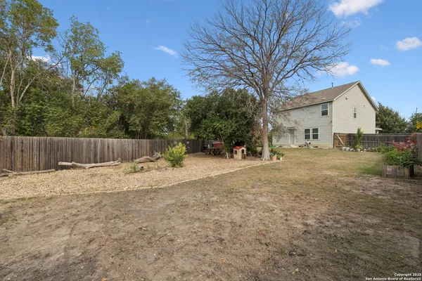 a backyard of a house with yard and outdoor seating