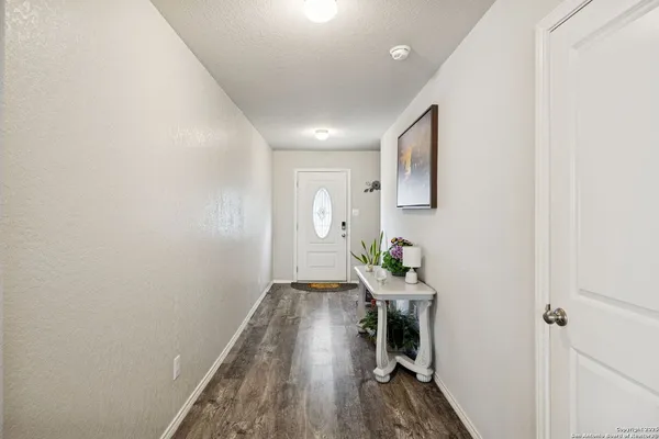 a living room with furniture flat screen tv and wooden floor