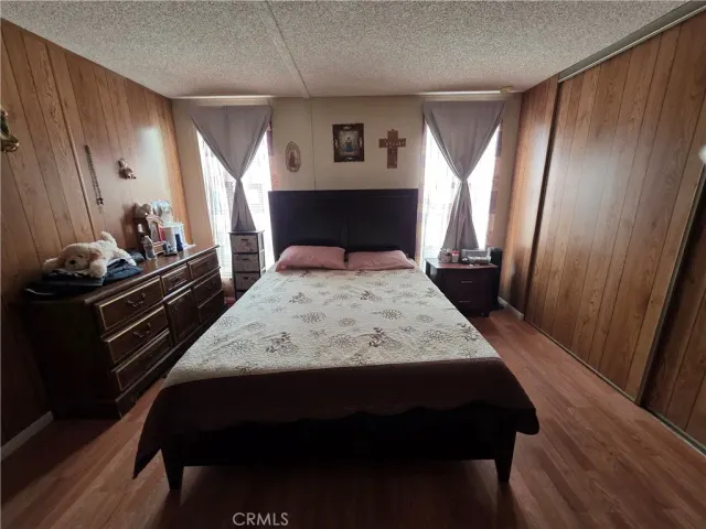 a large bed sitting in a bedroom next to a window