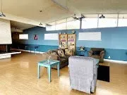 a living room with fireplace furniture and a window