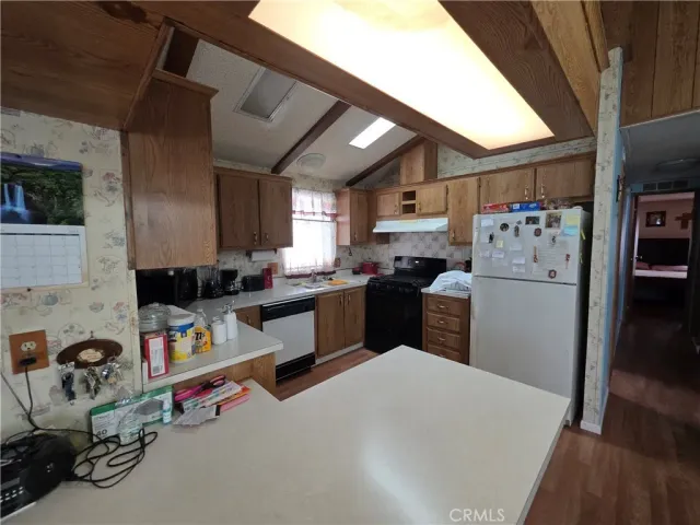 a kitchen with refrigerator and cabinets