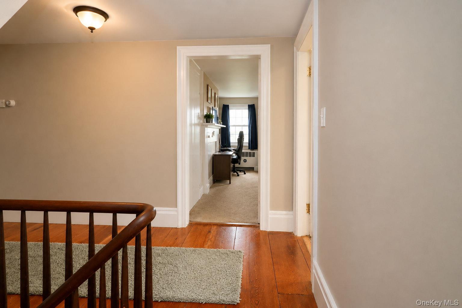 340 Dunn Road Montgomery, NY 12549 - Photo 19 of 34 View of the upstairs stairway railing, original wide wood plank flooring and a bedroom