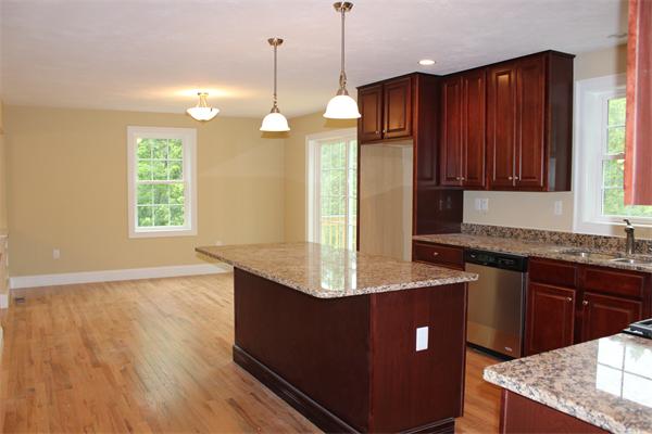 91 North Road Chelmsford, MA 01824 - Photo 5 of 27 a kitchen with kitchen island granite countertop wooden cabinets a sink a window and stainless steel appliances