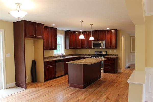 91 North Road Chelmsford, MA 01824 - Photo 6 of 27 a kitchen with stainless steel appliances granite countertop a refrigerator and a stove top oven