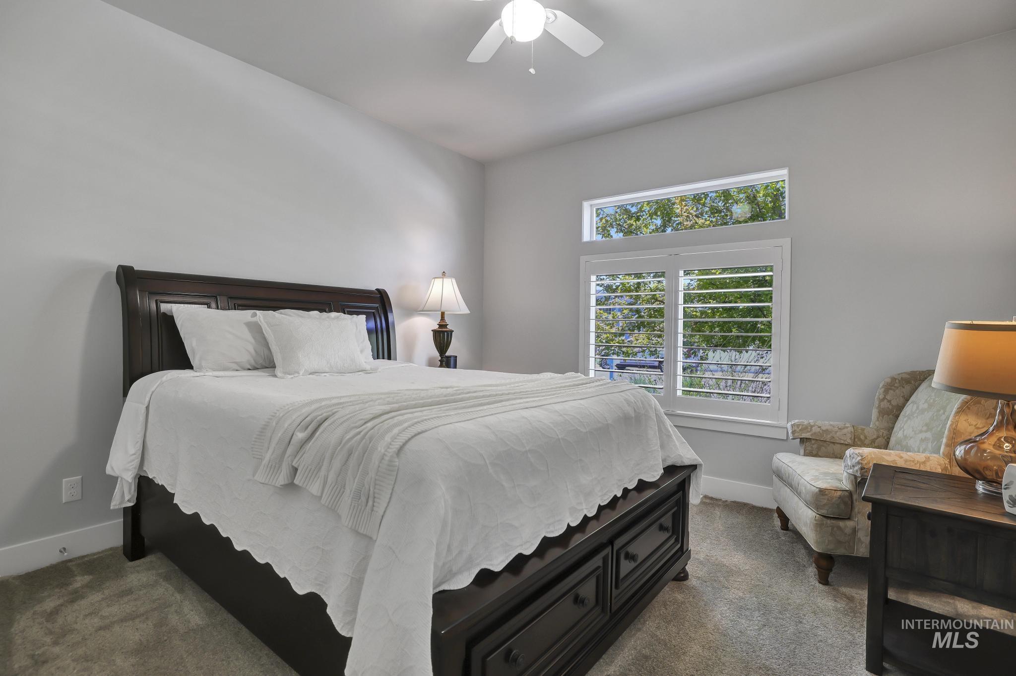 1937 Tamarack Loop Twin Falls, ID 83301 - Photo 24 of 50 Room featuring light gray walls, carpet flooring, a window with white plantation shutters, and a transom window above