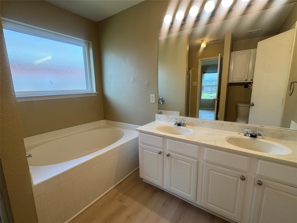 908 Cedar Ridge Lane Burleson, TX 76028 - Photo 13 of 24 a bathroom with a tub sink and mirror