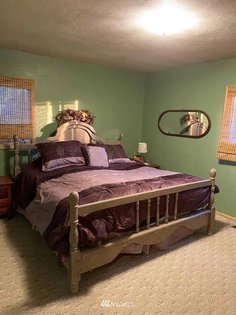 802 South 5th Street Dayton, WA 99328 - Photo 12 of 20 a bedroom with a bed and a chair