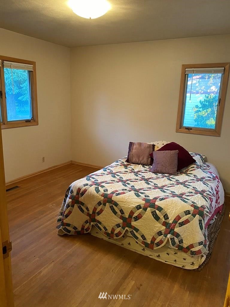 802 South 5th Street Dayton, WA 99328 - Photo 13 of 20 a bedroom with a bed and wooden floor