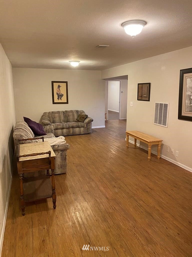 802 South 5th Street Dayton, WA 99328 - Photo 15 of 20 a living room with furniture and a wooden floor