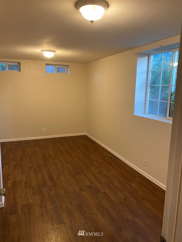 802 South 5th Street Dayton, WA 99328 - Photo 18 of 20 an empty room with wooden floor and windows