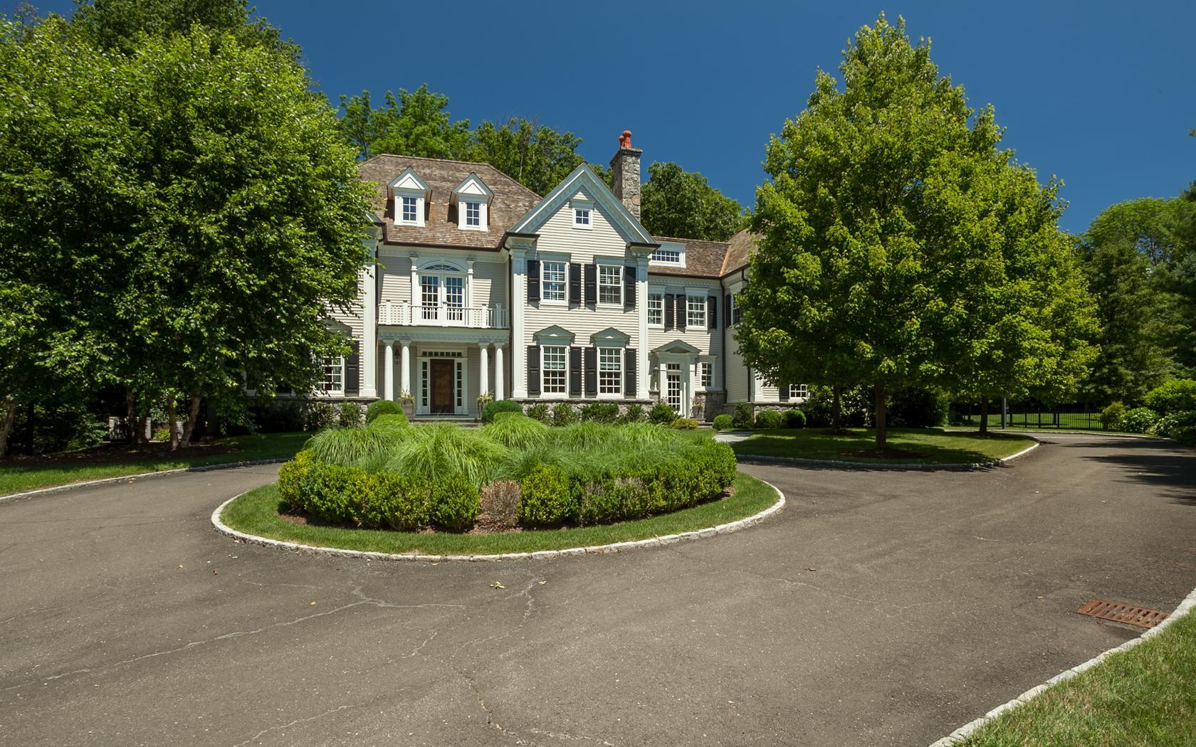 107 Dunning Road New Canaan, CT 06840 - Photo 1 of 31 a front view of a house with a garden