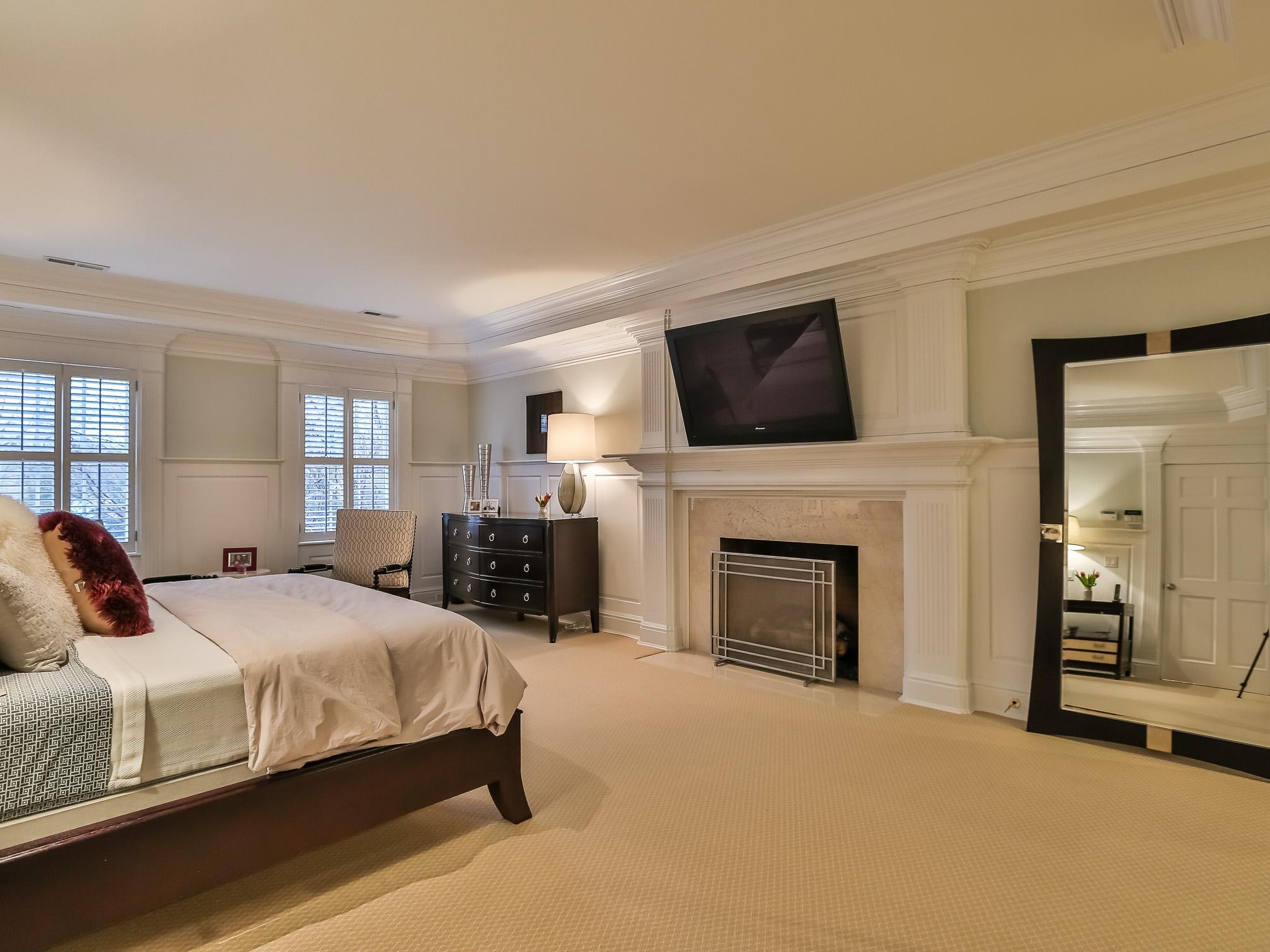 107 Dunning Road New Canaan, CT 06840 - Photo 17 of 31 a bedroom with a bed and a fireplace