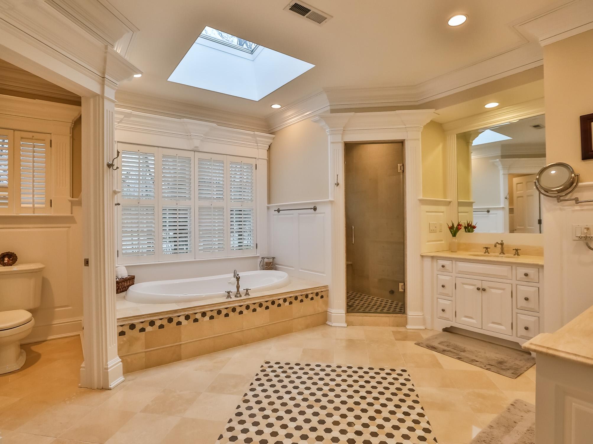107 Dunning Road New Canaan, CT 06840 - Photo 18 of 31 a spacious bathroom with a tub sink shower and mirror