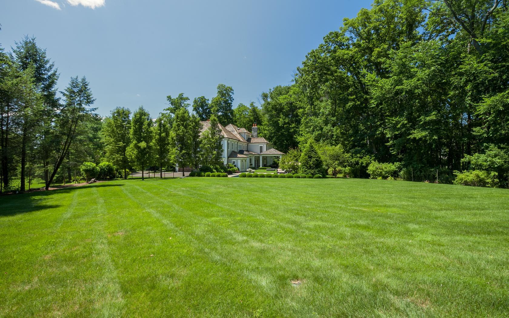 107 Dunning Road New Canaan, CT 06840 - Photo 31 of 31 a view of a field with plants and trees in the background
