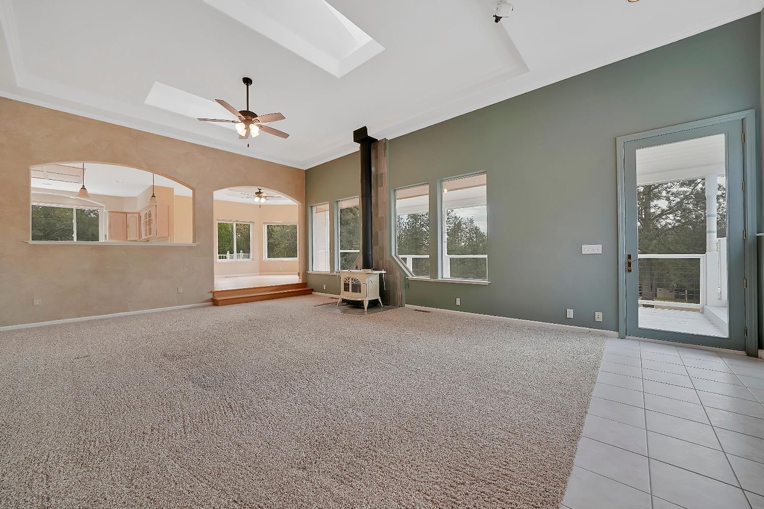 13901 Chestnut Lane Sutter Creek, CA 95685 - Photo 17 of 46 Living room offers deck access, wood-burning stove and built-in shelves