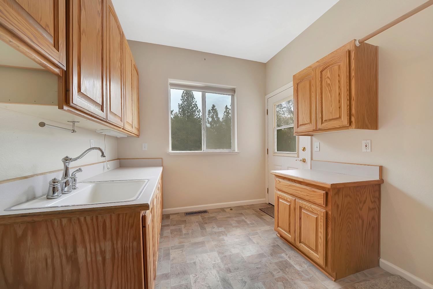 13901 Chestnut Lane Sutter Creek, CA 95685 - Photo 29 of 46 ULTRA laundry room! Deck access, sink, cabinets galore, and room for that additional fridge!
