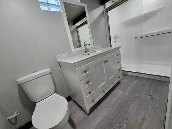 a bathroom with a toilet sink and mirror