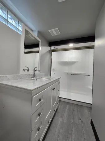 a bathroom with a double vanity sink and mirror