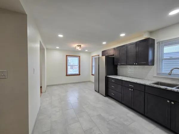 a view of a kitchen with a sink and cabinets