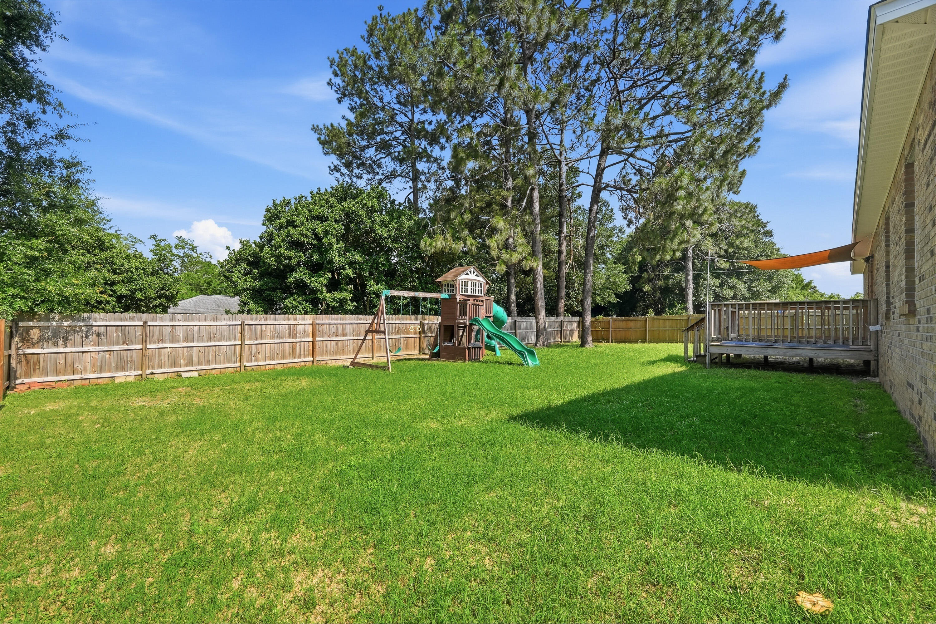 3033 Cabela Lane Crestview, FL 32539 - Photo 32 of 32 a view of a yard with a slide