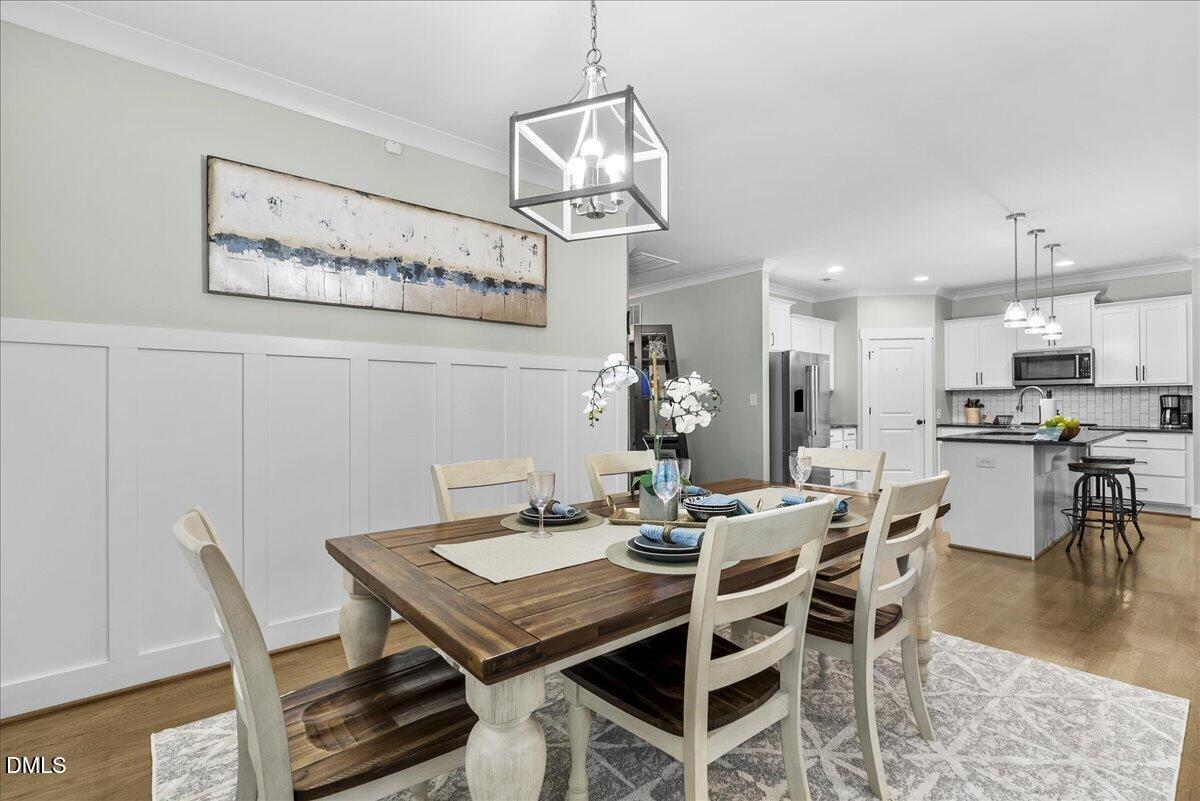 47 Kiowa Court Willow Spring, NC 27592 - Photo 13 of 30 a view of a dining room with furniture wooden floor and a chandelier