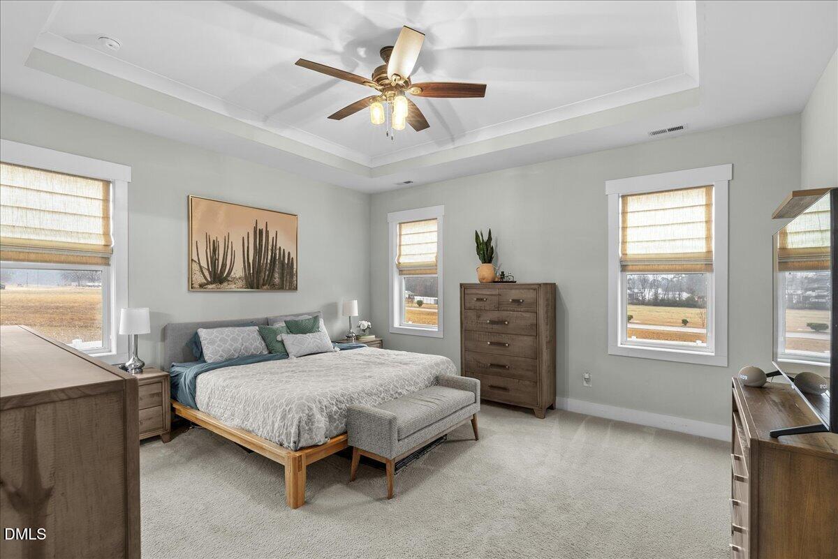 47 Kiowa Court Willow Spring, NC 27592 - Photo 14 of 30 a bedroom with a bed a dresser and a window