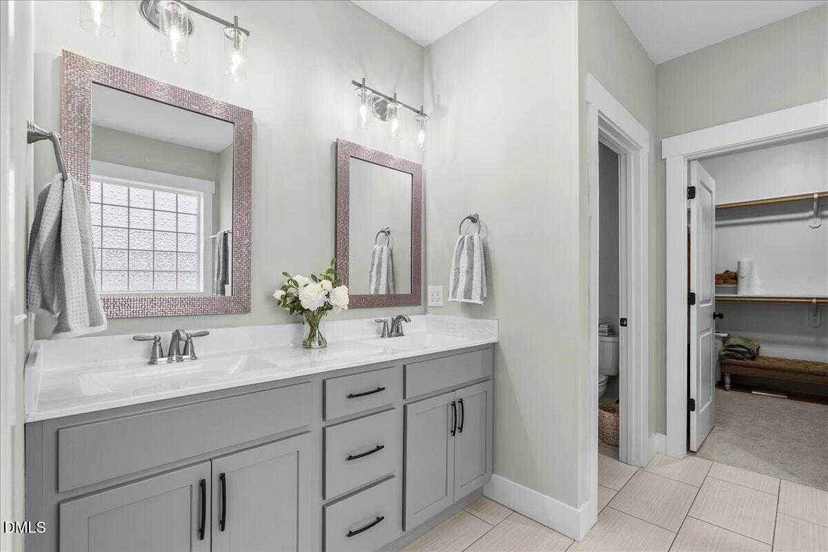 47 Kiowa Court Willow Spring, NC 27592 - Photo 15 of 30 a bathroom with a double vanity sink mirror and