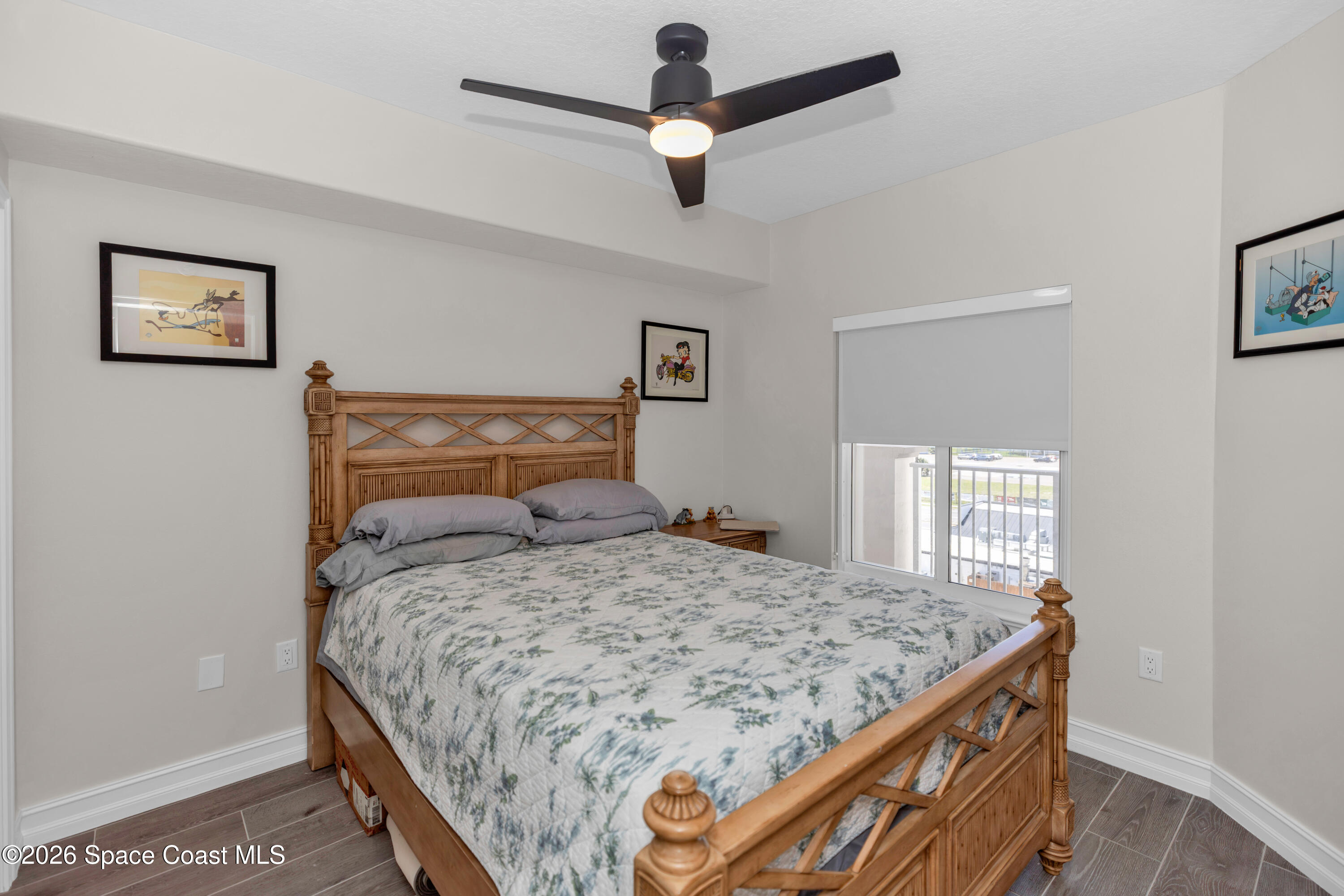 1805 Riverside Drive, Unit 506 Titusville, FL 32780 - Photo 17 of 24 a bedroom with a bed and a chandelier