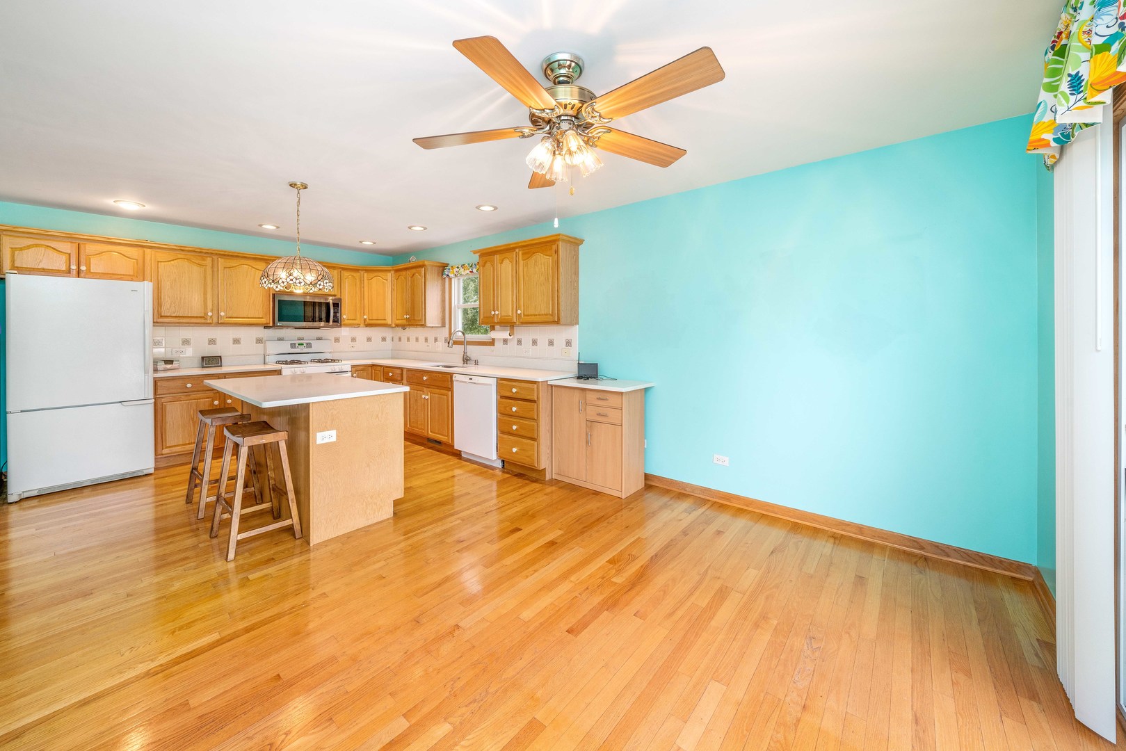 3970 East 2259th Road Serena, IL 60549 - Photo 4 of 39 a kitchen with stainless steel appliances granite countertop a stove top oven a sink a dining table and chairs with wooden floor