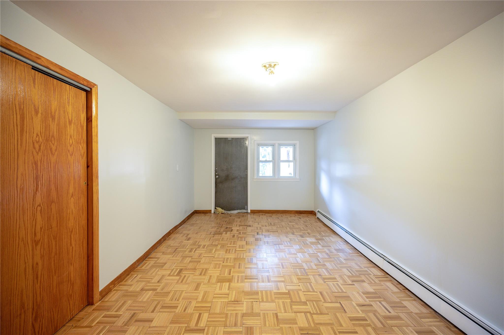 59-38 Xenia Street Queens, NY 11368 - Photo 13 of 16 a view of empty room with window