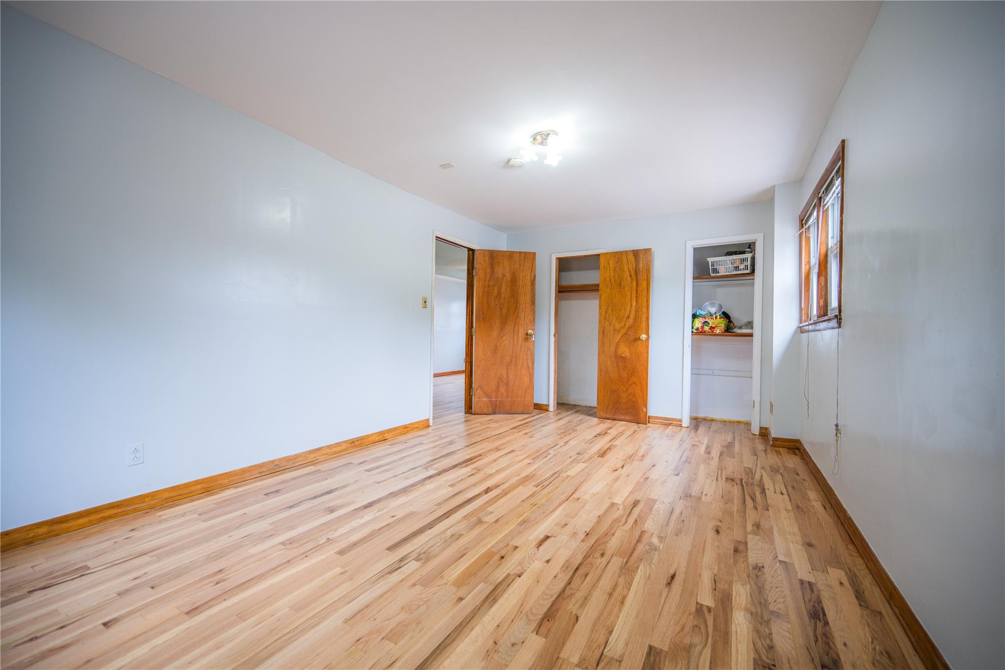 59-38 Xenia Street Queens, NY 11368 - Photo 15 of 16 a view of an empty room with wooden floor