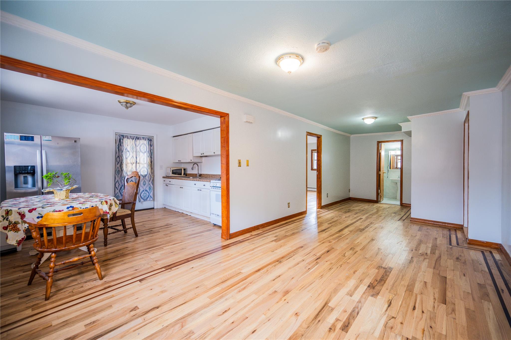 59-38 Xenia Street Queens, NY 11368 - Photo 5 of 16 a view of a dining room with furniture and wooden floor