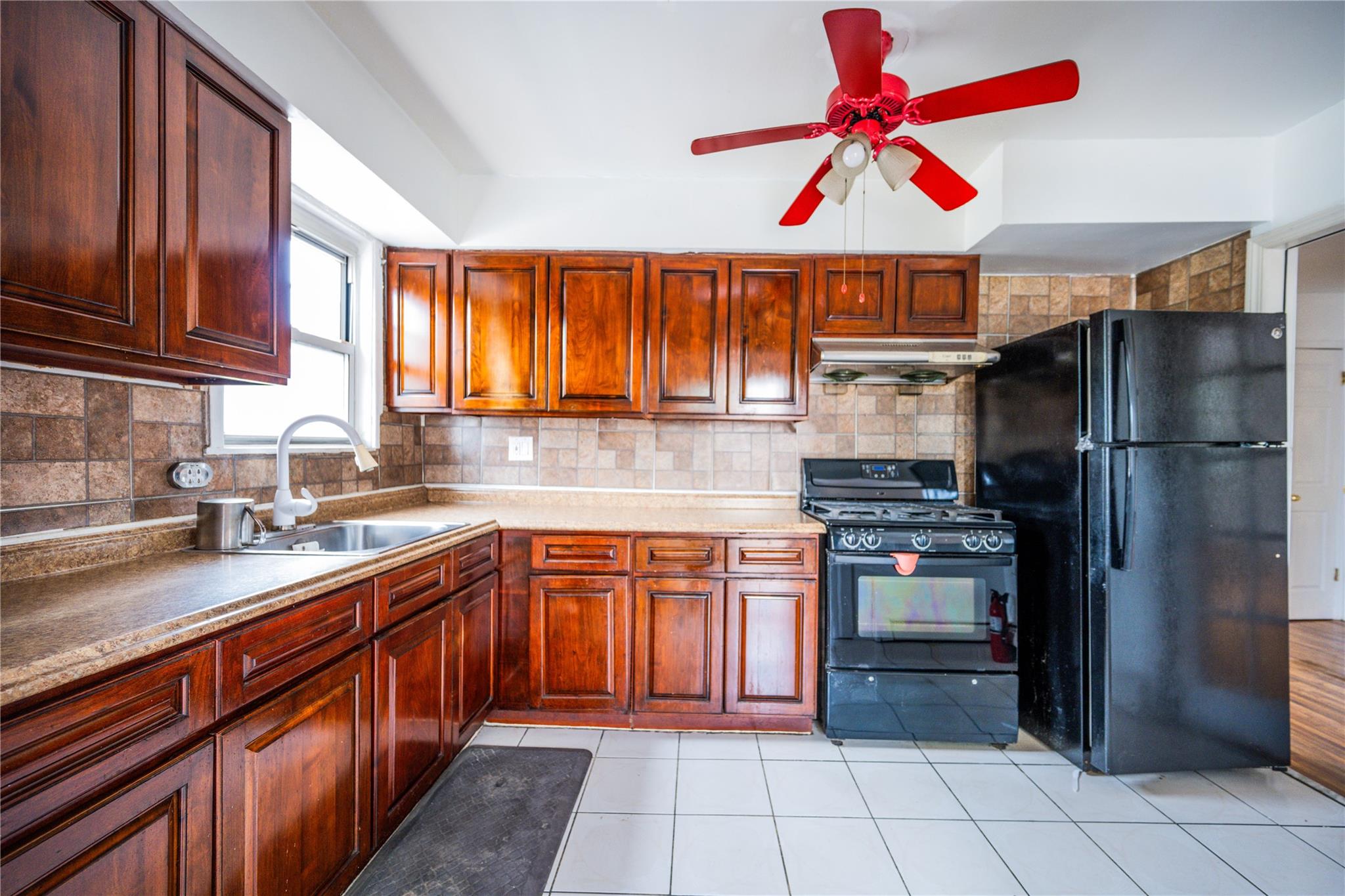 59-38 Xenia Street Queens, NY 11368 - Photo 7 of 16 a kitchen with stainless steel appliances granite countertop a refrigerator and a sink