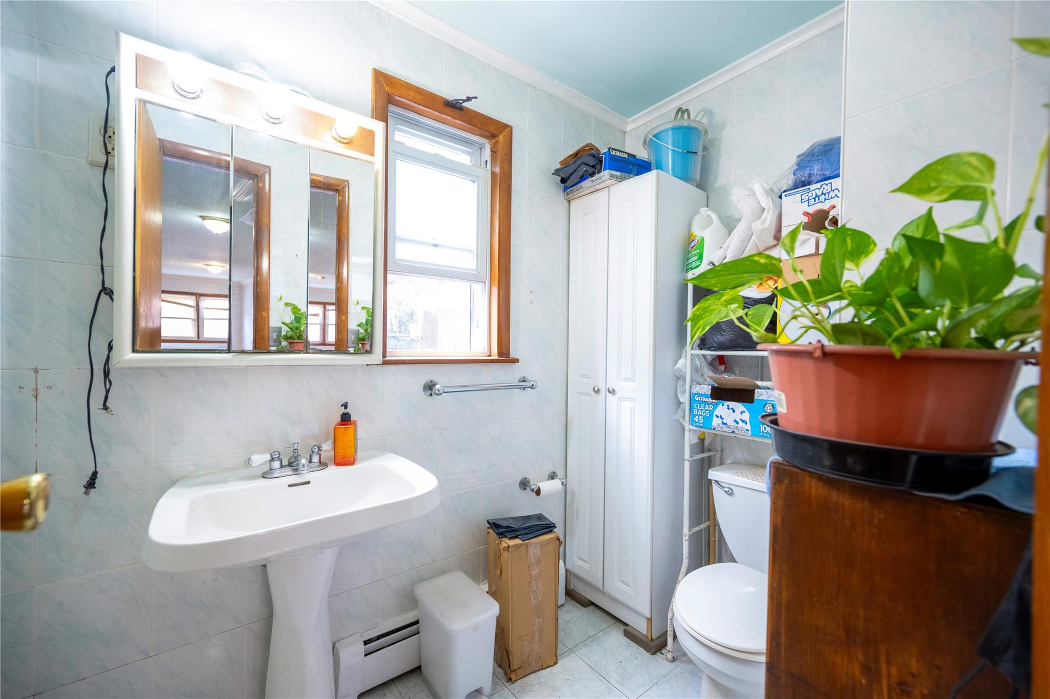 59-38 Xenia Street Queens, NY 11368 - Photo 8 of 16 a bathroom with a sink toilet and shower