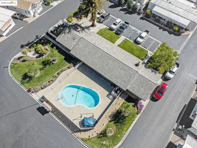 an aerial view of a house with a swimming pool and outdoor seating