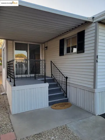 a view of a porch with wooden floor and fence
