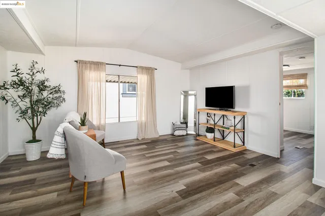 a bedroom with furniture and a flat screen tv